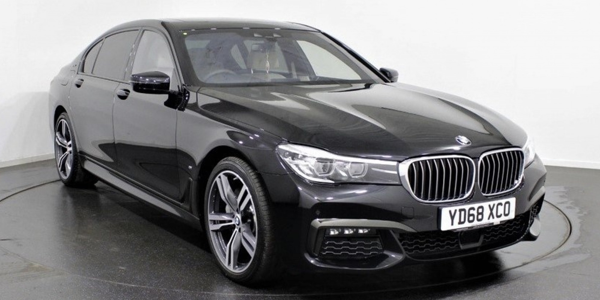 Black BMW 7 Series parked three-quarters facing right